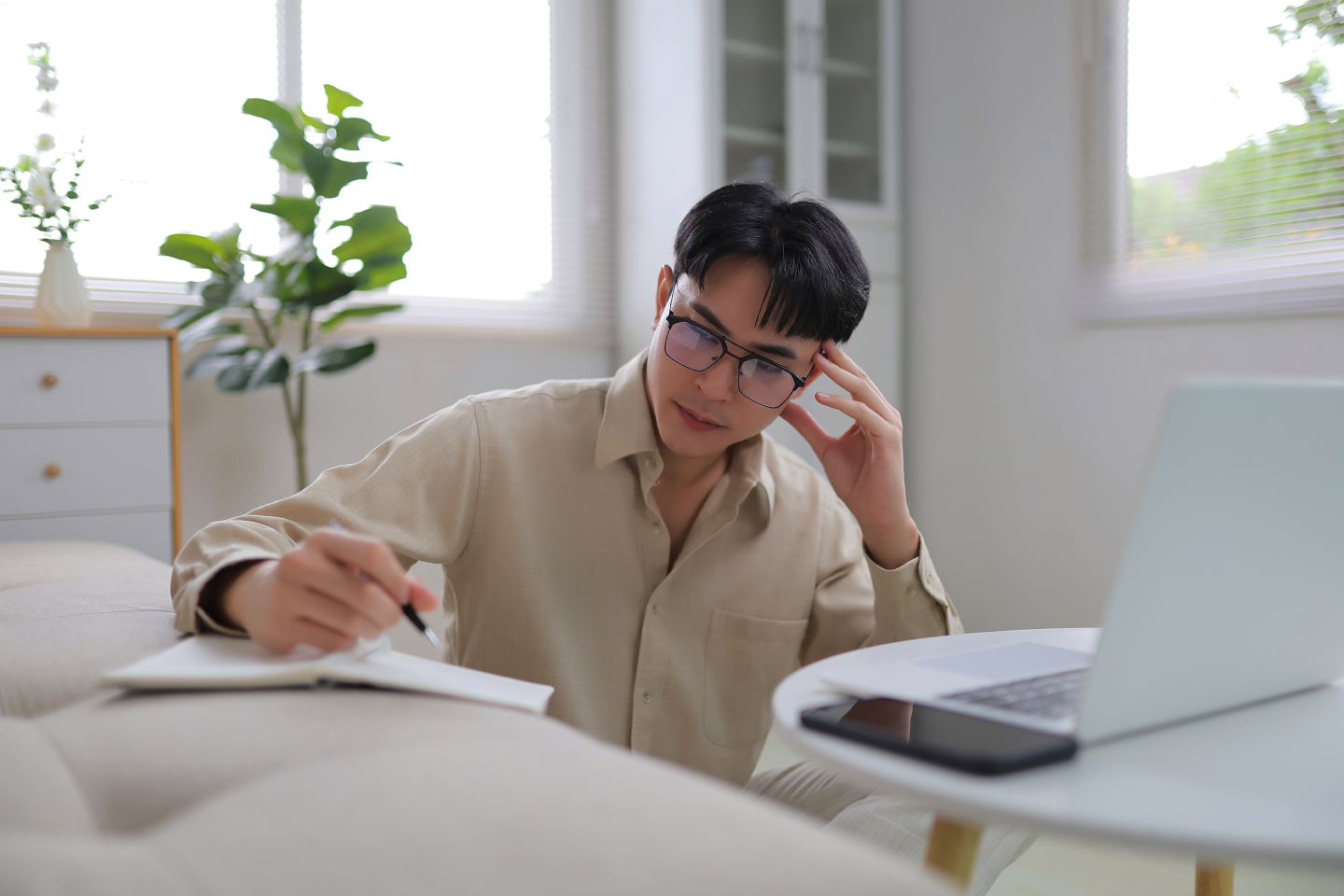 Person wearing glasses working in front of a computer