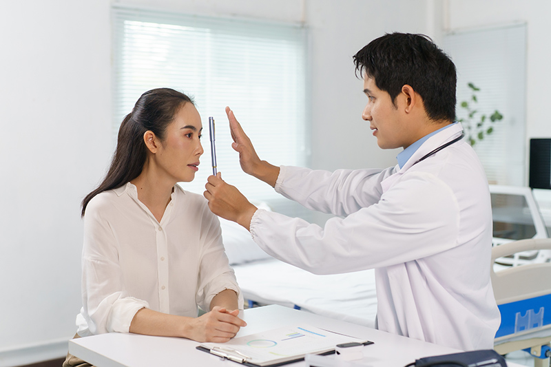 Ophthalmologist performing a vision examination on a patient during a glaucoma screening.